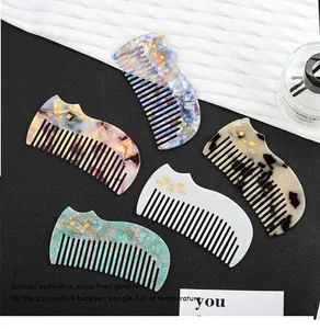 Close-up of cute cat-shaped acetate hair combs in various colors and patterns