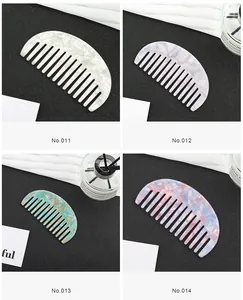 Detail view of four semi-circle acetate hair combs with marble patterns in diverse colors