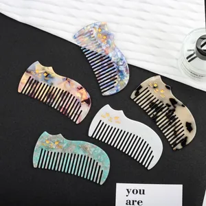Cat-shaped acetate hair combs in various colors with elegant vintage design and gold accents
