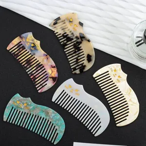 Vintage cat-shaped acetate hair combs in various marble and tortoiseshell patterns