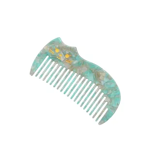 Retro cat ear shaped acetate hair comb with blue marble texture and gold cat face detail
