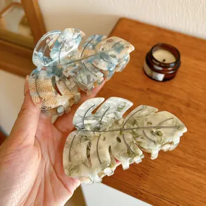 Set of two acetate monstera leaf hair claws with elegant marble patterns in blue and green
