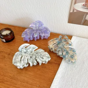 Elegant monstera leaf acetate hair claw clips with marble texture in three colors