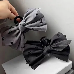 Large elegant fabric bow hair claw clips in grey and black with mini butterfly prints