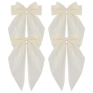 Set of four oversized beige satin bow hair clips with long elegant flowing ribbons