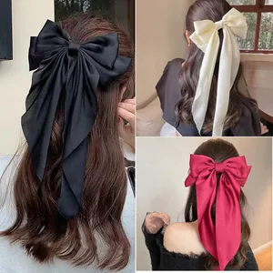 Oversized satin bow hair clip with long ribbons in black, beige and burgundy colors