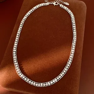 Detailansicht einer dreireihigen Strass-Halskette auf einem braunen Schmuckständer