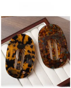 Detailed macro view of tortoiseshell acetate hair claws with premium cutout design