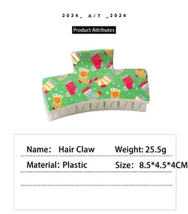 Detailed view of a Christmas hair claw clip with a green holiday pattern and size specs