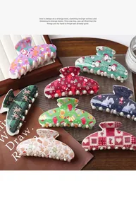 Detailed view of large Christmas hair claws featuring festive prints and polished finish