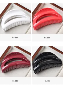 Detail of four semi-circle hollow hair claws in white, red, burgundy and black finishes