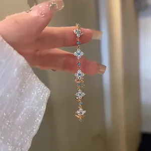 Close-up of 18k gold-plated clover bracelet with zircon and turquoise stones