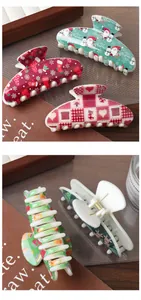Macro detail of Christmas hair clips showing festive prints and strong gold metal springs
