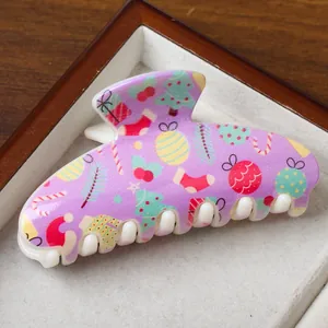 Festive large Christmas claw clip in purple with holiday icons and glossy finish