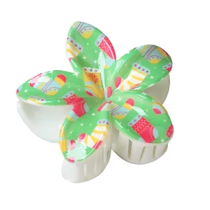Pince à cheveux fleur avec motifs de Noël sur une base en résine vert vif