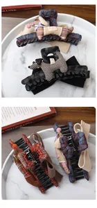 Detail of checkered bow hair claw clip featuring a handmade plush puppy and marble decor