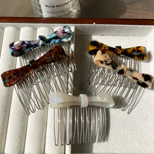 Elegant bow-shaped acetate hair combs in various leopard and floral patterns on white velvet