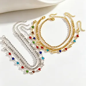 Detail view of 3-piece adjustable anklet set with colorful heart charms in gold and silver