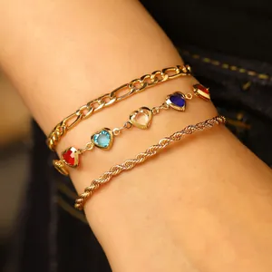 Macro view of bohemian gold anklet set featuring colorful heart-shaped crystal charms