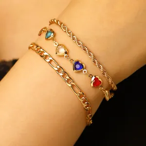 Close-up of Bohemian 3-piece anklet set with colorful heart charms and gold chains.