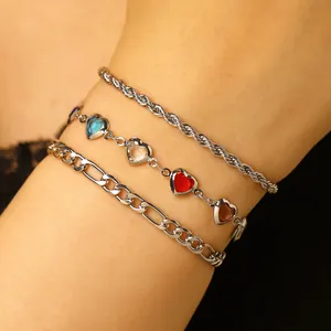 Detailed view of three layered silver anklets featuring vibrant heart-shaped stones