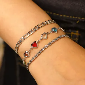 Detail view of a set of three adjustable silver anklets with colorful heart-shaped charms