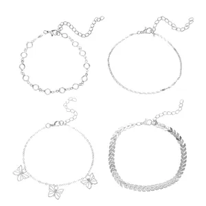 Detail view of 4-piece Bohemian silver anklet set featuring butterfly and chevron designs