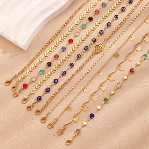 Detailed view of layered bohemian gold anklets with colorful beads and charms.