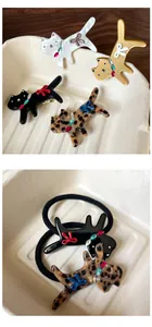 Detailed view of leopard cat hair clips with rhinestone bow decorations and hair ties