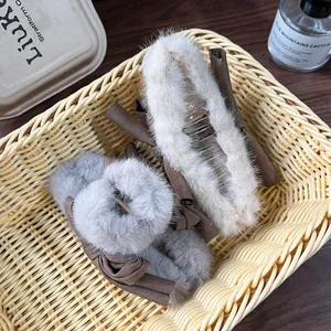 Winter plush bow hair claw clips in beige and grey colors with soft faux fur finish