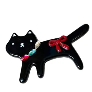 Cute black cat hair clip with red bow and colorful gems on white background