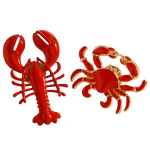 Close-up detail of vibrant red lobster and crab enamel alloy brooches for beach style