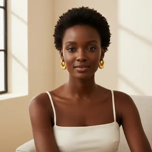 Professional portrait of a model wearing chunky gold double-hoop stainless steel earrings