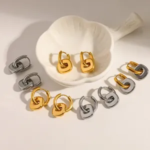 Detailed view of geometric stainless steel hoop earrings in gold and silver finishes.