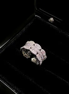 Macro detail of an elegant silver lace open ring with shimmering cubic zirconia.