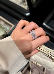 Close-up of a stylish zircon lace open ring worn on a finger