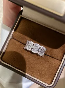 Detail of zircon lace open ring with sparkling stones in a premium brown jewelry box