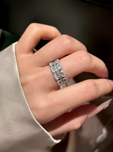 Macro view showing the intricate zircon lace-edge detailing on an elegant silver ring