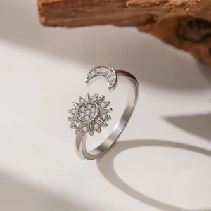 Detail view showing a silver adjustable sun and moon ring with sparkling zircon stones