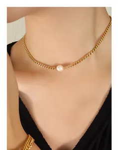 Close-up of a minimalist gold collar chain with a single round white pearl for women