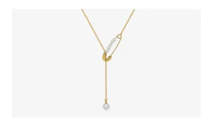 Detailed view of 18k gold pin pendant necklace with dangling pearls and Y-shaped chain