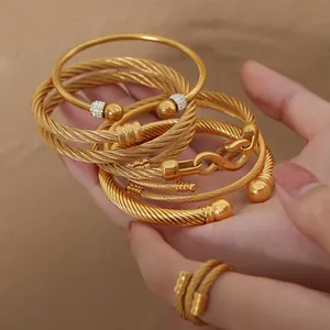 Gold cable motif bangles and ring set with sparkling zircon in a luxurious style