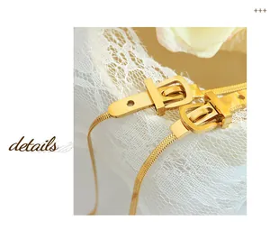 Detail of gold snake chain necklace featuring a unique belt buckle style clasp design