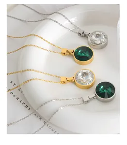 Close-up of elegant round crystal pendant necklaces in gold and silver plating on white plate