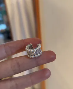 Detail view of a French vintage zircon and pearl ear cuff for non-pierced ears