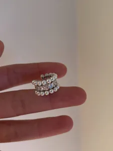 Detailed macro view of French vintage style ear cuff with pearls and cubic zirconia stones