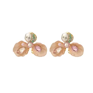 Elegant French style flower stud earrings featuring delicate pearls and sparkling rhinestones