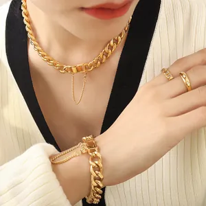 Golden chunky Cuban chain necklace and bracelet set with rings on a female model