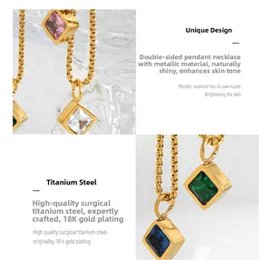 Detail of 18K gold plated titanium necklace with emerald glass and zirconia pendants