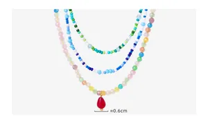 Detail of bohemian layered necklace with faceted natural crystals and colorful beads